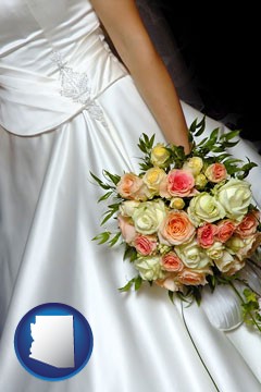 a bride, wearing a white wedding dress and holding a beautiful bridal bouquet - with Arizona icon