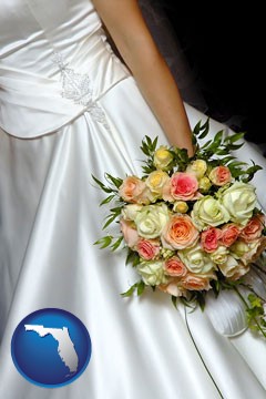 a bride, wearing a white wedding dress and holding a beautiful bridal bouquet - with Florida icon