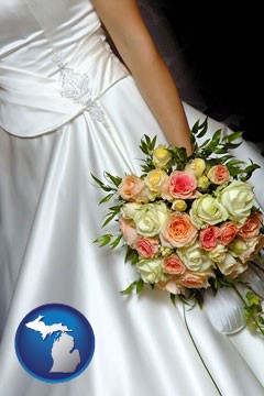 a bride, wearing a white wedding dress and holding a beautiful bridal bouquet - with Michigan icon