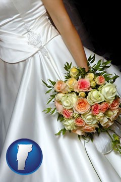 a bride, wearing a white wedding dress and holding a beautiful bridal bouquet - with Vermont icon
